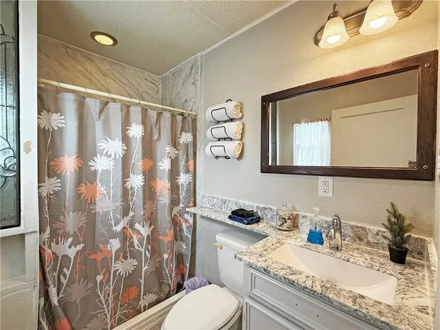 a bedroom with a bed and a view of kitchen