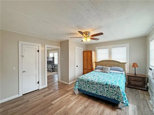 a kitchen with stainless steel appliances granite countertop a stove top oven a refrigerator a sink and dishwasher with wooden floor