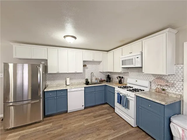 a dining room with furniture and kitchen view