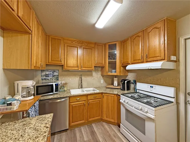 a kitchen with a stove a sink and a refrigerator