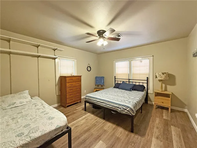 a bedroom with a bed table and chair