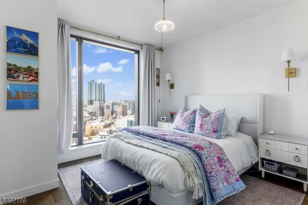 a bedroom with a bed and a large window