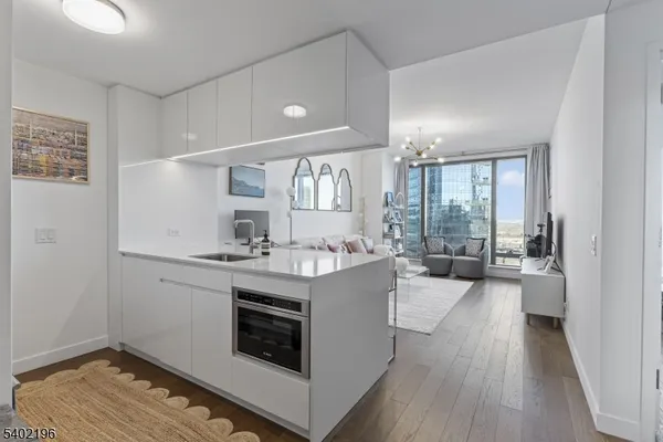a view of kitchen with sink and wooden floor