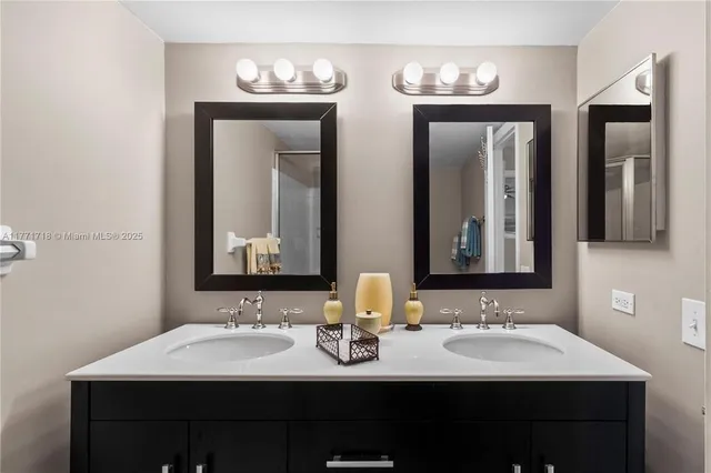 a bathroom with a double vanity sink and a mirror
