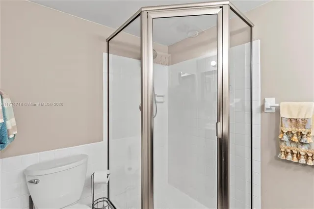 a bathroom with a shower and a toilet in it