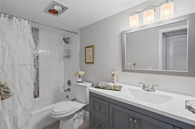 a bathroom with a granite countertop sink toilet a large mirror and shower