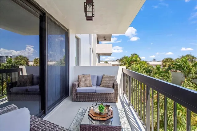 a balcony with furniture and a potted plant