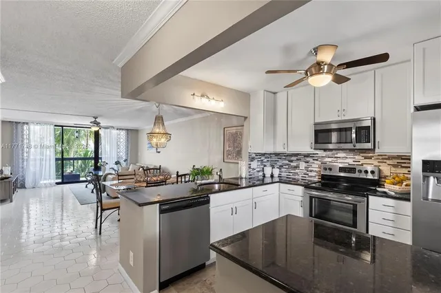 a kitchen with a sink stove and microwave