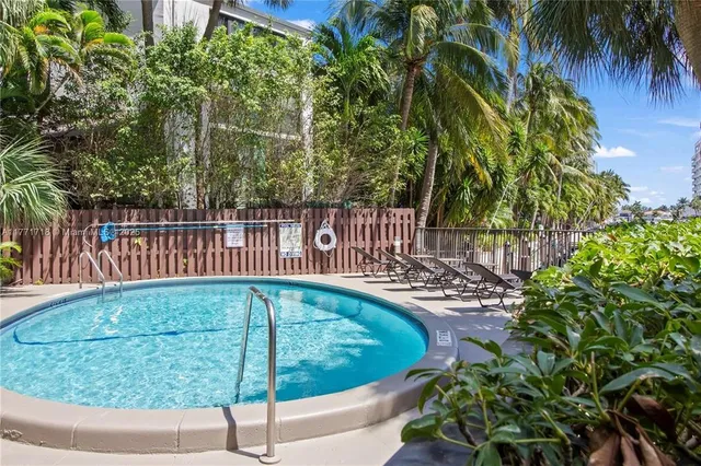 a view of a patio with couches and table and chairs and potted plants