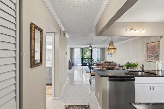 a kitchen with sink and refrigerator