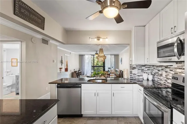 a kitchen with stainless steel appliances a sink stove and refrigerator