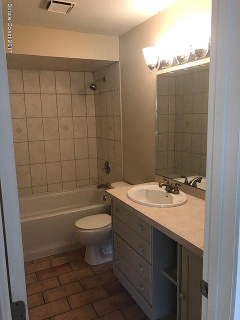 3685 Longbow Road Cocoa, FL 32926 - Photo 11 of 17 a bathroom with a sink a toilet and shower