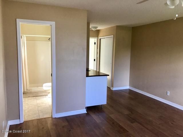 3685 Longbow Road Cocoa, FL 32926 - Photo 13 of 17 an empty room with wooden floor and door