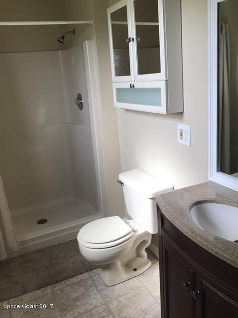 3685 Longbow Road Cocoa, FL 32926 - Photo 14 of 17 a white toilet sitting next to a bathroom sink