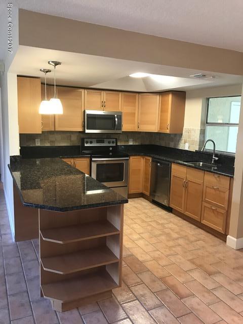 3685 Longbow Road Cocoa, FL 32926 - Photo 4 of 17 a kitchen with stainless steel appliances granite countertop a sink and cabinets