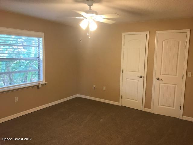 3685 Longbow Road Cocoa, FL 32926 - Photo 5 of 17 en empty room with windows and chandelier fan