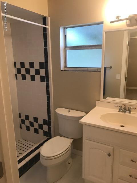 3685 Longbow Road Cocoa, FL 32926 - Photo 6 of 17 a bathroom with a sink a toilet and shower