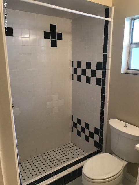 3685 Longbow Road Cocoa, FL 32926 - Photo 8 of 17 a bathroom with a toilet and a shower