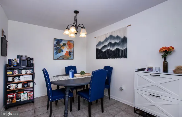 a view of a dining room with furniture and chandelier