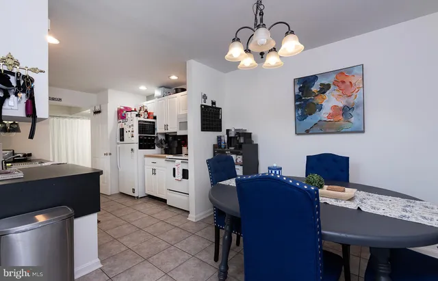 a view of a dining room with furniture and a chandelier fan
