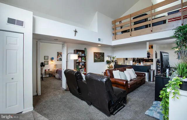 a living room with furniture and a gym