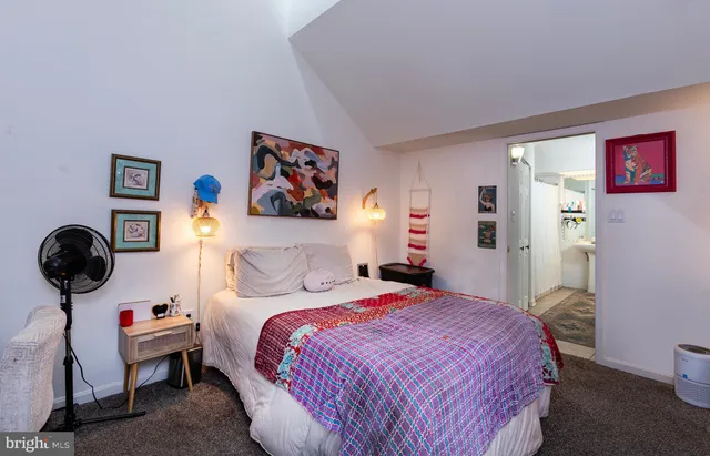 a bedroom with a bed and a painting on the wall