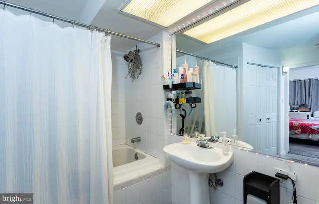 a bathroom with a sink a mirror and a shower