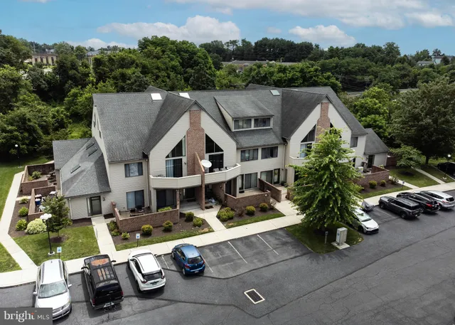 an aerial view of a house with swimming pool and garden