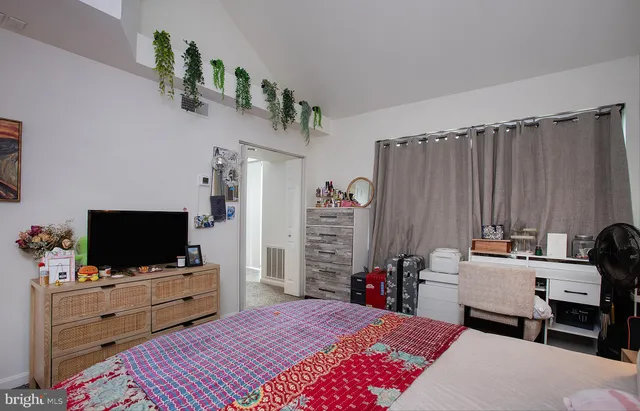 a room with a bed and a flat screen tv