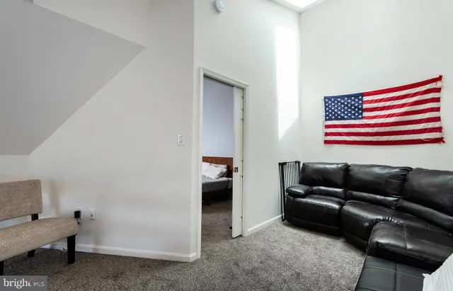 a living room with furniture and a air conditioner vent