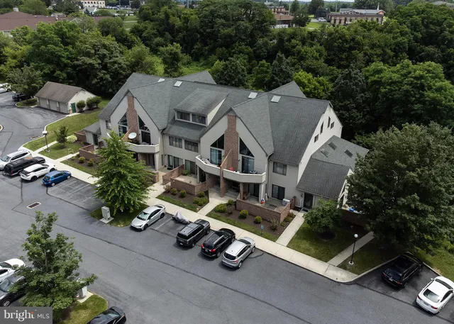 an aerial view of a house with garden space and street view