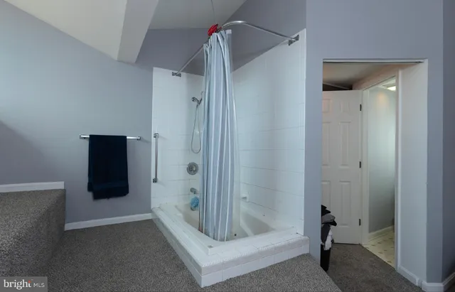 a bathroom with a glass shower door
