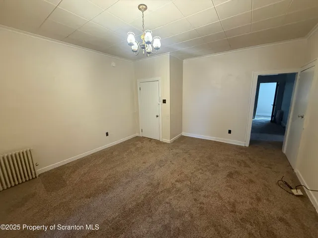 a view of a chandelier in big room and chandelier
