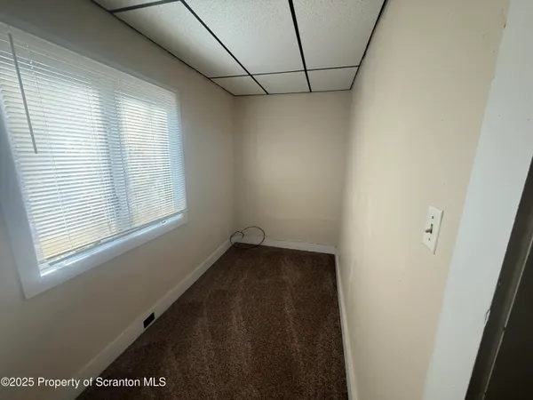 a view of a room with tiles and windows