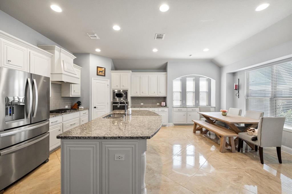 7235 Neblina Drive Grand Prairie, TX 75054 - Photo 11 of 32 a kitchen with stainless steel appliances granite countertop a sink stove and refrigerator