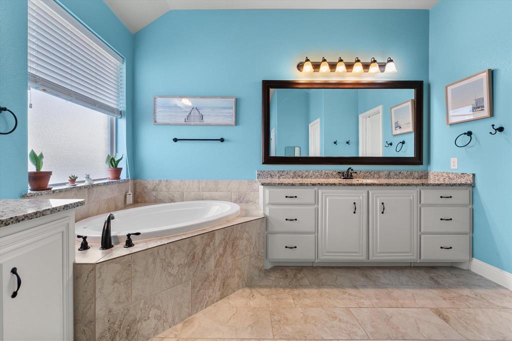 7235 Neblina Drive Grand Prairie, TX 75054 - Photo 17 of 32 a spacious bathroom with a tub sink and mirror