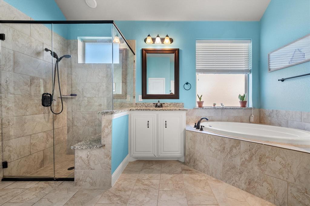 7235 Neblina Drive Grand Prairie, TX 75054 - Photo 18 of 32 a spacious bathroom with a tub sink and mirror