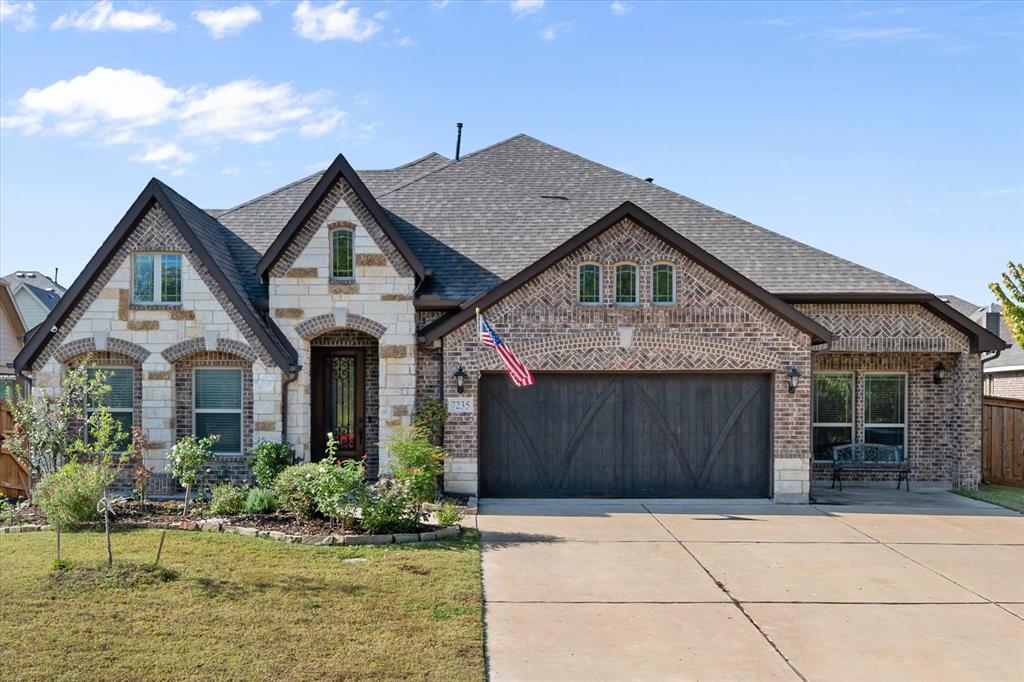 7235 Neblina Drive Grand Prairie, TX 75054 - Photo 2 of 32 a front view of a house with a yard