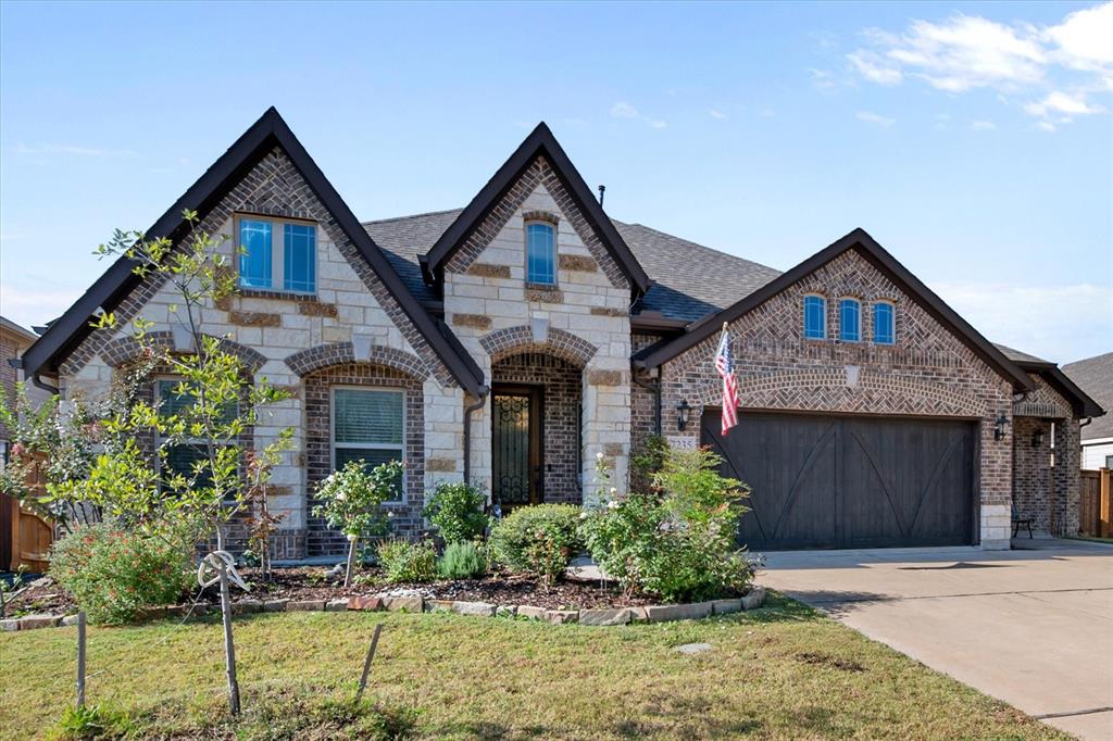 7235 Neblina Drive Grand Prairie, TX 75054 - Photo 3 of 32 a front view of a house with garden