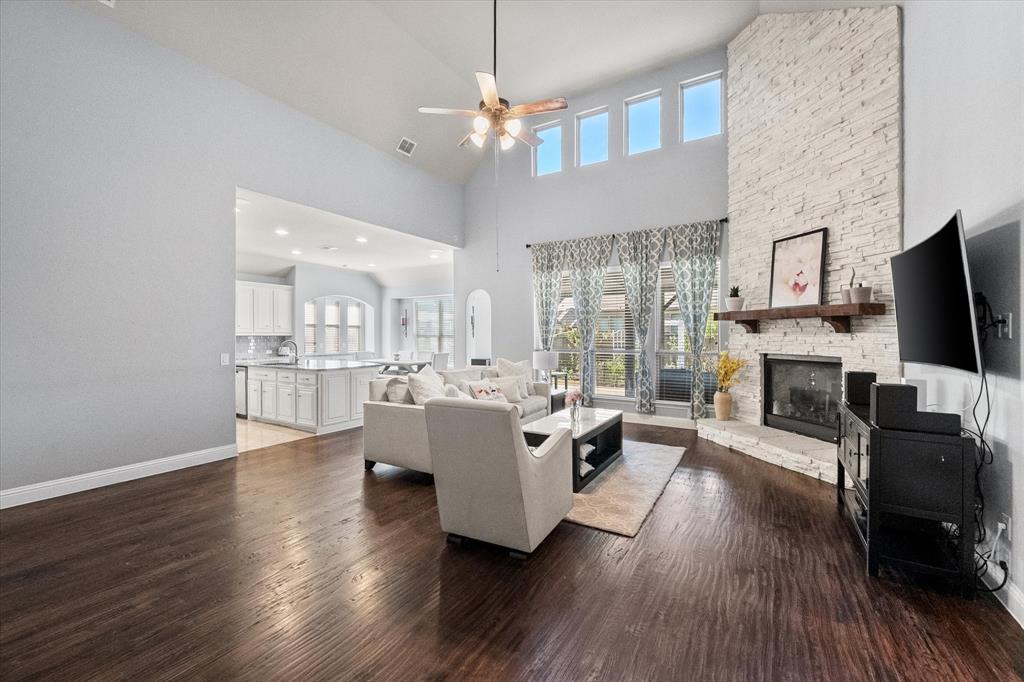 7235 Neblina Drive Grand Prairie, TX 75054 - Photo 5 of 32 a living room with fireplace furniture and a flat screen tv