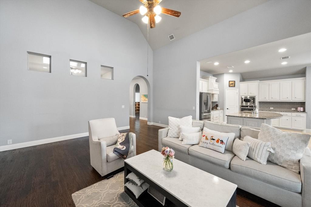 7235 Neblina Drive Grand Prairie, TX 75054 - Photo 8 of 32 a living room with furniture and a chandelier