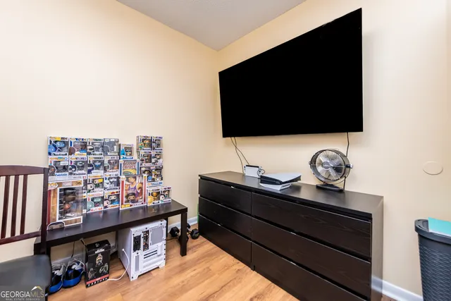a flat screen tv sitting on top of a wooden floor