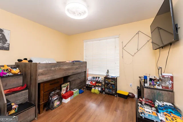 a storage room with lots of stuff and wooden floor