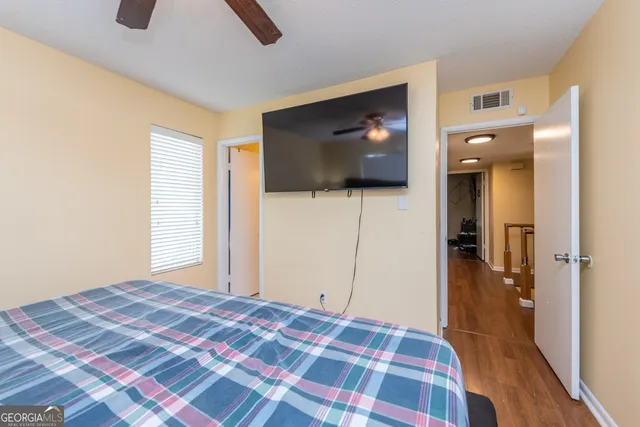 a bedroom with a bed and a flat screen tv
