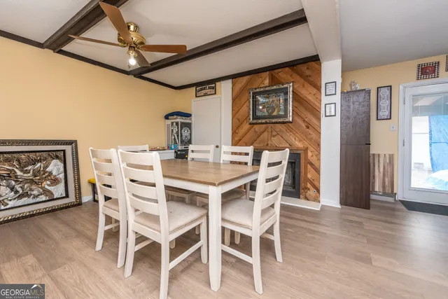 a dining room with furniture a chandelier and wooden floor