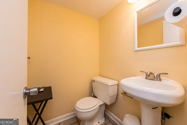 a bathroom with a sink mirror and toilet