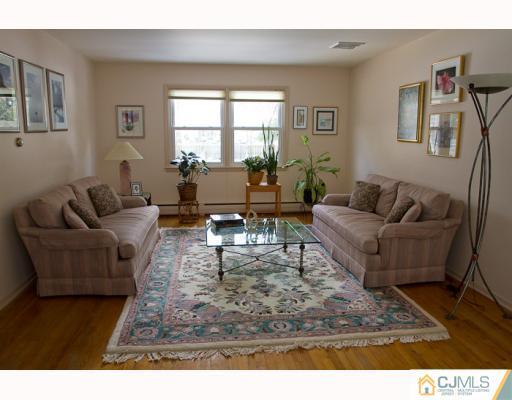 11 Devon Road Edison, NJ 08820 - Photo 2 of 23 a living room with furniture wooden floor and a rug