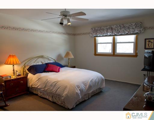 11 Devon Road Edison, NJ 08820 - Photo 11 of 23 a bedroom with a bed and a chandelier