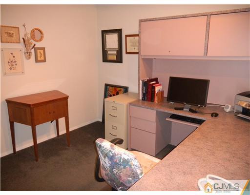 11 Devon Road Edison, NJ 08820 - Photo 16 of 23 a room with a couch and a flat screen tv