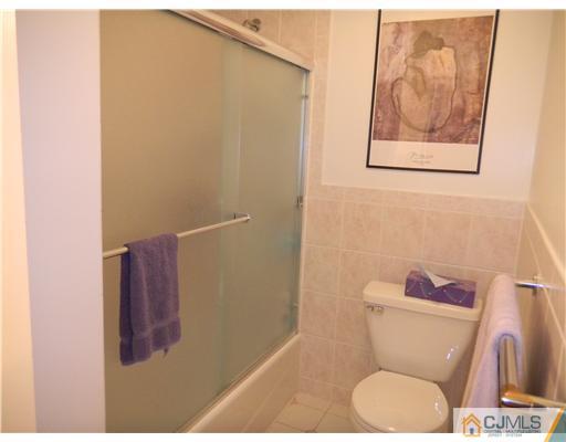 11 Devon Road Edison, NJ 08820 - Photo 18 of 23 a white toilet sitting next to a shower curtain
